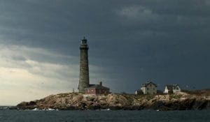 A lighthouse on the shore of an island.