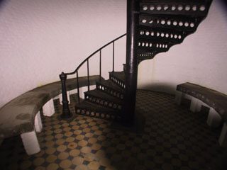 a room with stairs and sitting arrangement