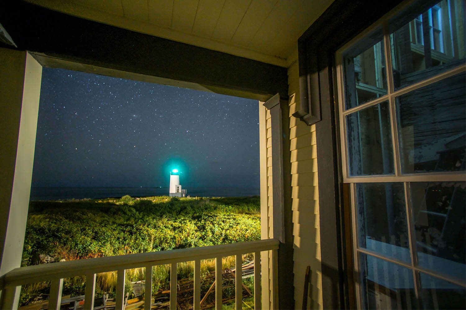 A view of a lighthouse from the porch.