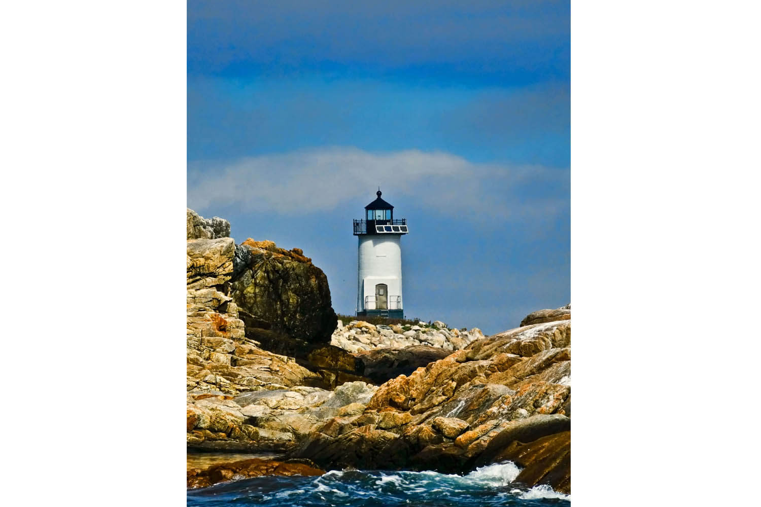 A lighthouse on the rocks near water
