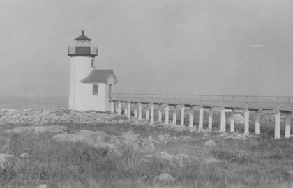 A black and white photo of a lighthouse.