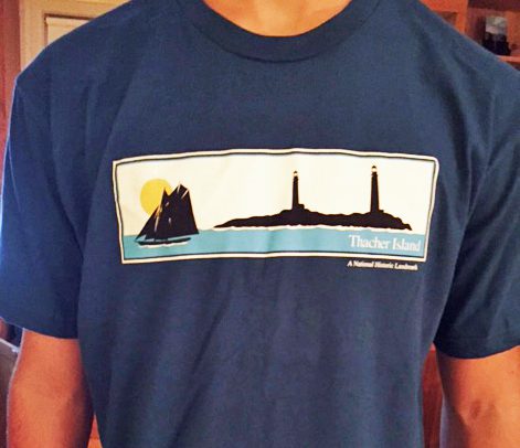 A man wearing a t-shirt with the image of a lighthouse.