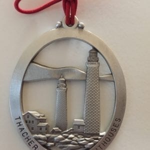 A silver ornament with the name of thacker island.