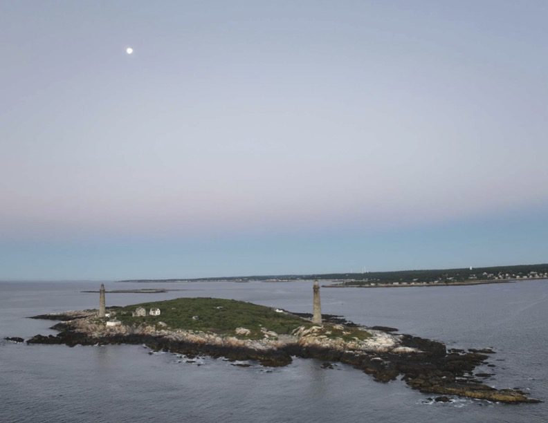 A view of the moon and some light houses.
