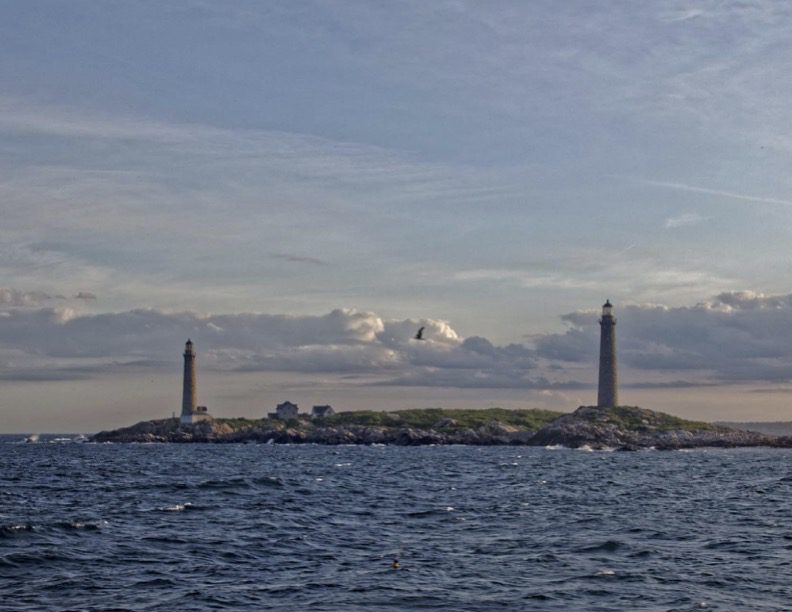A view of two lighthouses from the water.