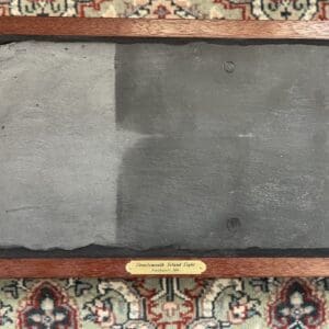 A picture of the back of a slate on a wall.